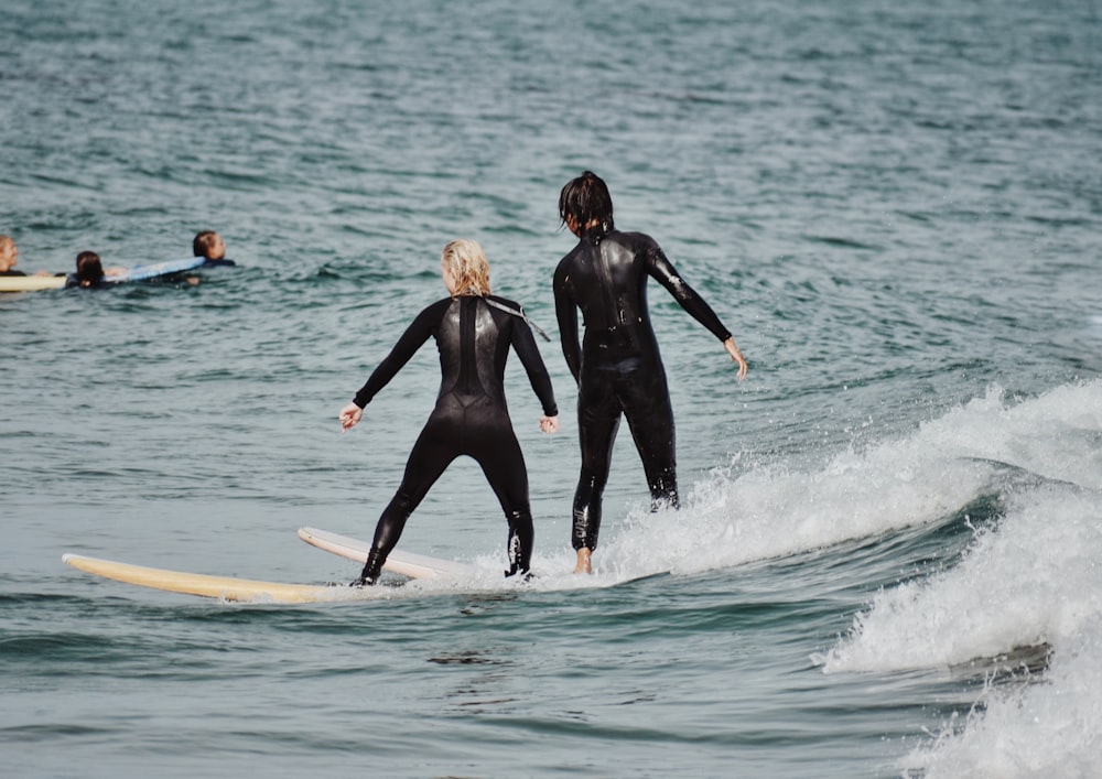 a couple of women surfing in the sea