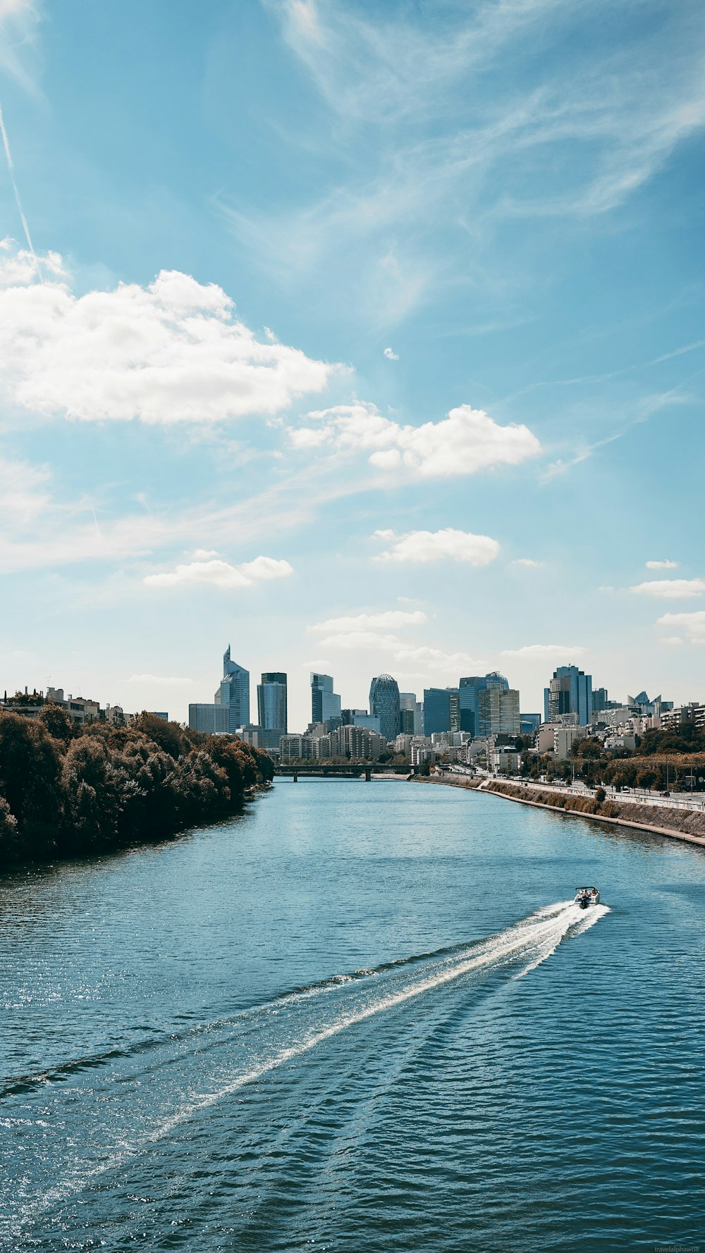 a body of water with a city in the background