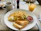 Close-up of a delicious arrachera omelette served with a steaming cup of traditional Mexican coffee.