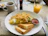 Close-up of a delicious arrachera omelette served with a steaming cup of traditional Mexican coffee.