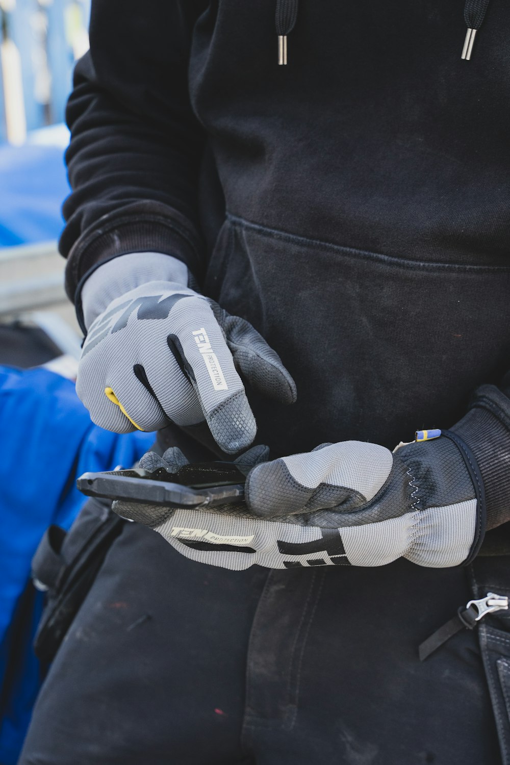 a gloved hand holding a glove