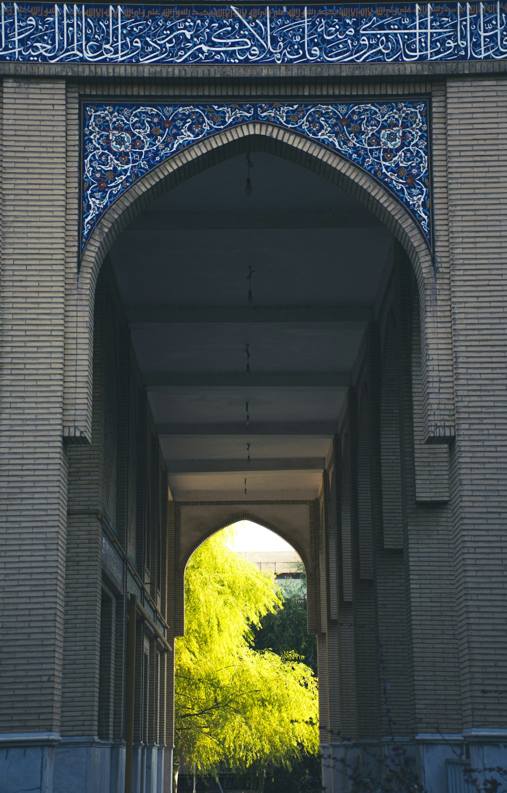 a stone archway with a tree in the middle