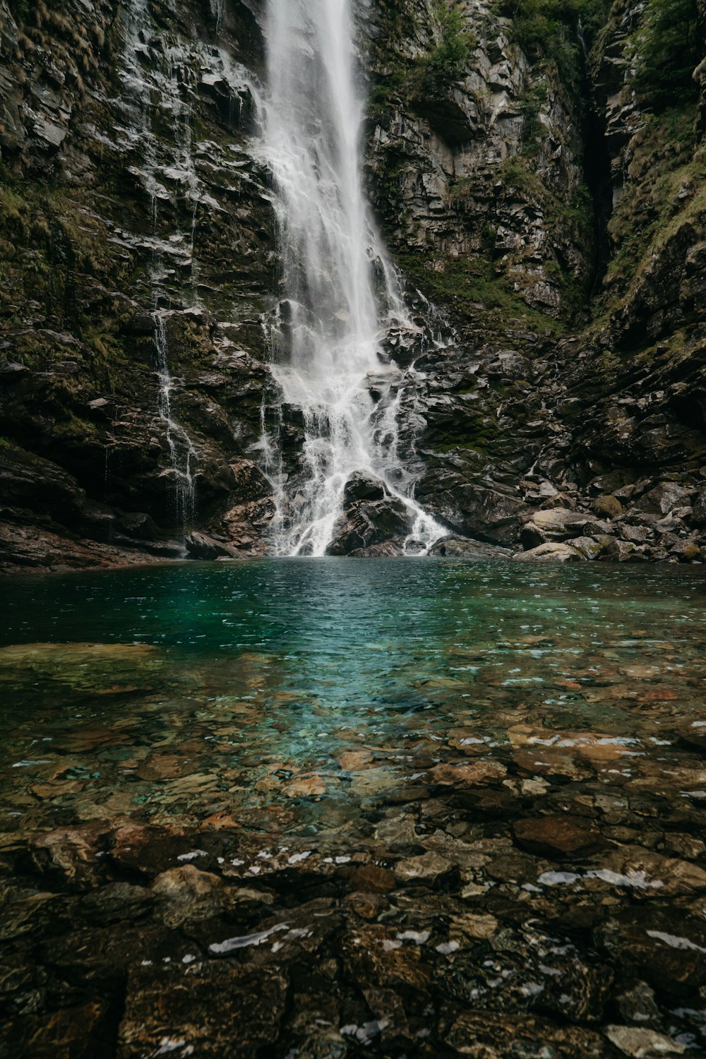 a waterfall over a rocky cliff