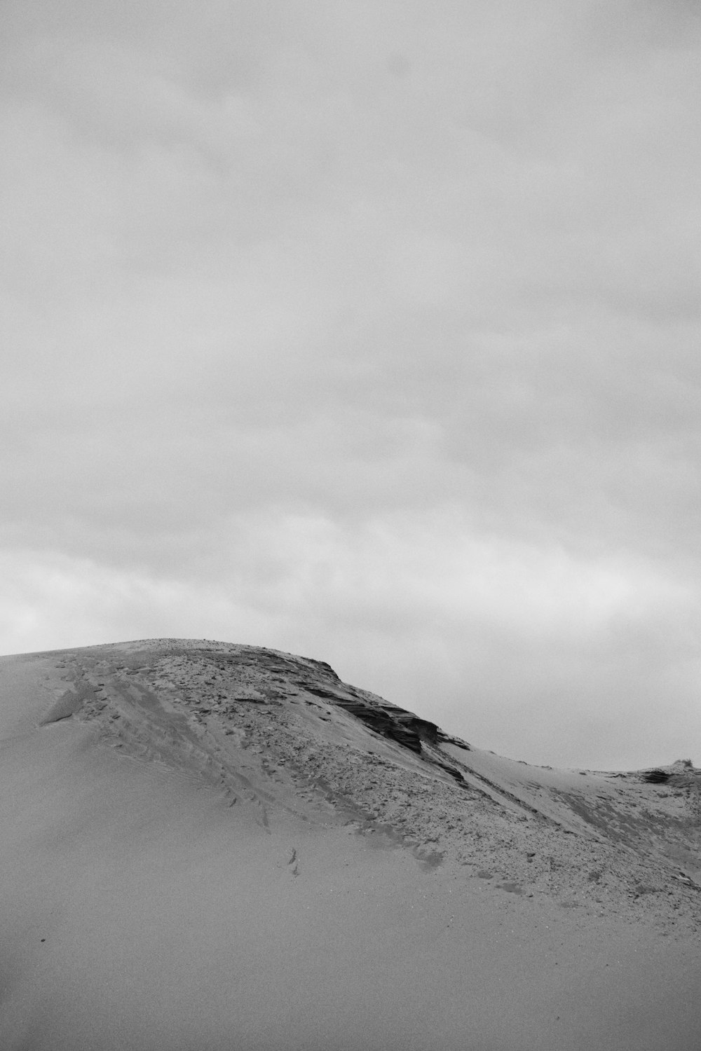 a snowy mountain with a cloudy sky