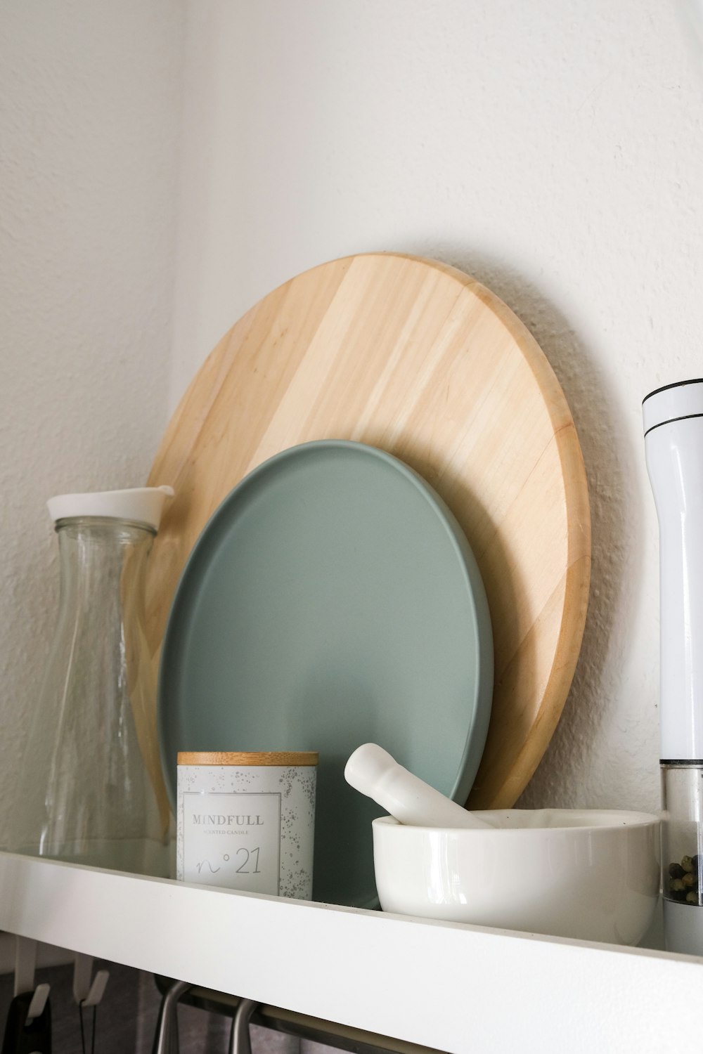 a vase and a bowl on a shelf