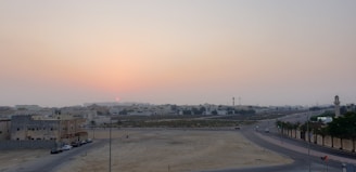 Sunset over open plots ready for development in Gurugram.