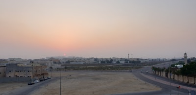 Sunset over open plots ready for development in Gurugram.