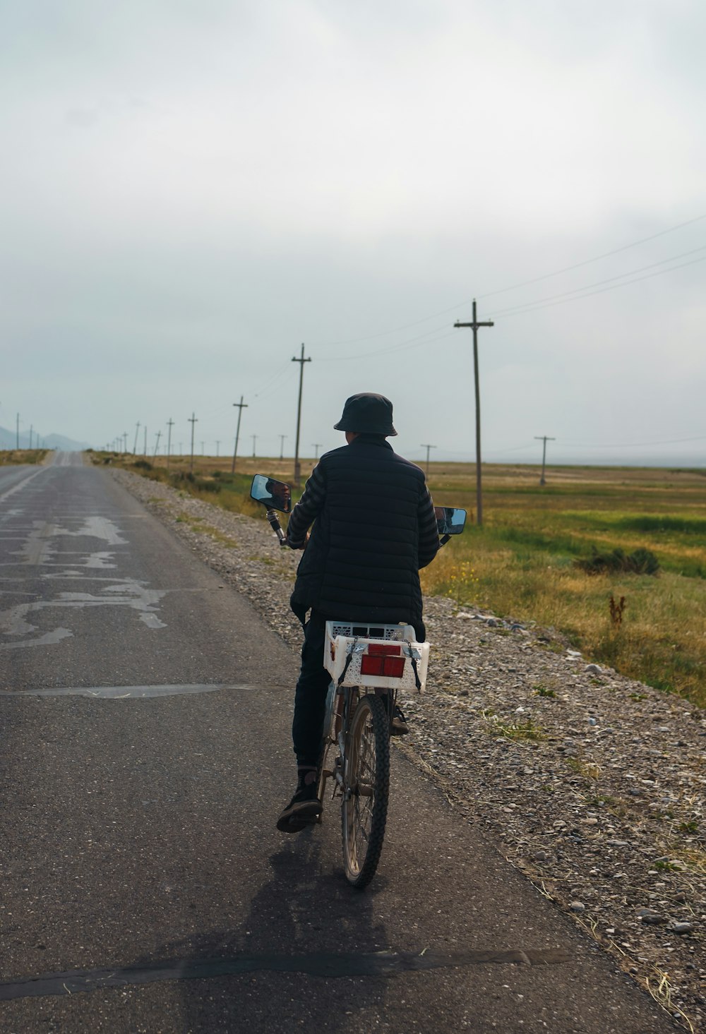 a person riding a bicycle on a road