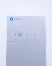 a white rectangular object with a blue circle on it