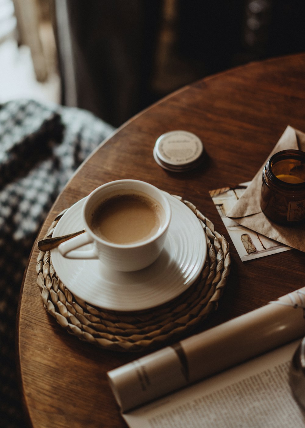 a cup of coffee on a saucer on a table