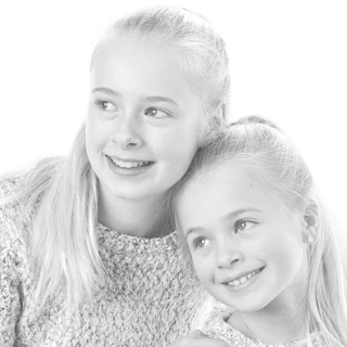 Two siblings smiling together, representing siblingship testing