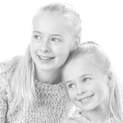 Two siblings smiling together, representing siblingship testing