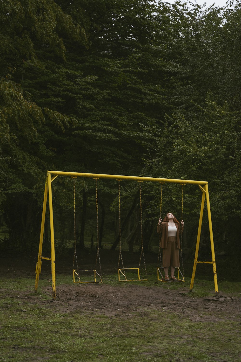 a person standing on a swing set