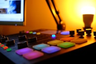 Mixing console with colorful LED lights glowing during a late-night session.