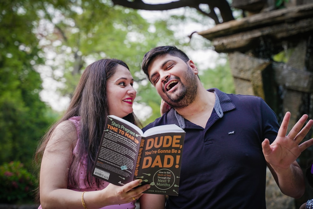 a man and woman holding books