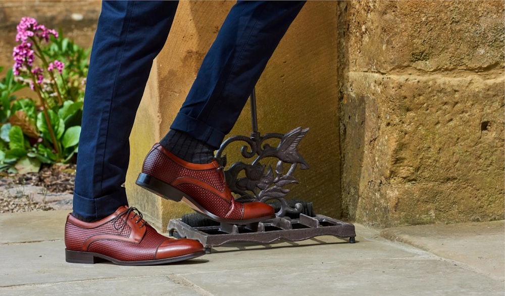 a person's feet with red shoes and a butterfly on their feet