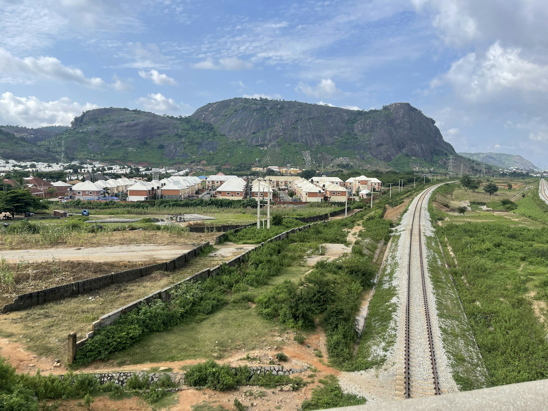 woman wearing yellow long-sleeved dress under white clouds and blue sky during daytime