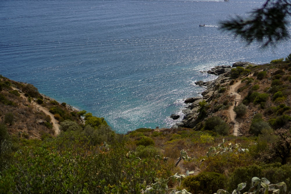 a rocky beach with a body of water in the background