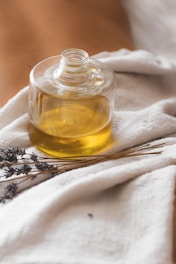 a glass jar with a yellow liquid