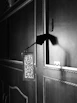 Hand holding a delicate double-layer acrylic door sign with intricate design
