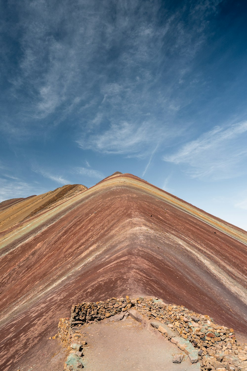 a dirt road with a dirt hill