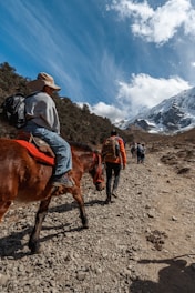 a person riding a horse on a rocky trail