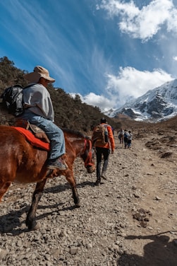 a person riding a horse on a rocky trail