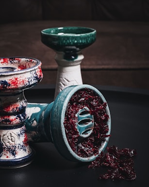 a couple of glass vases with colorful designs