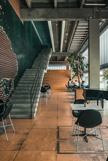 a group of people sitting at tables in a building
