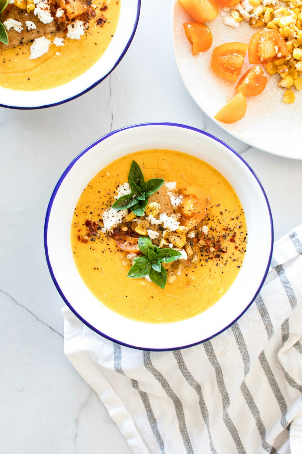 a bowl of soup with a leaf on top