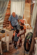 A warm photo of a volunteer gently listening to a community member in a cozy room.
