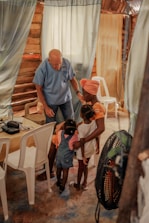 Volunteers assisting elderly people in a comfortable, cozy living space.