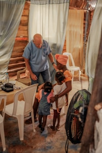 A warm family gathering with seniors sharing stories and laughter in a cozy living room.