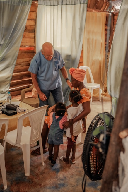 Volunteers interacting with children in a warm and friendly environment.