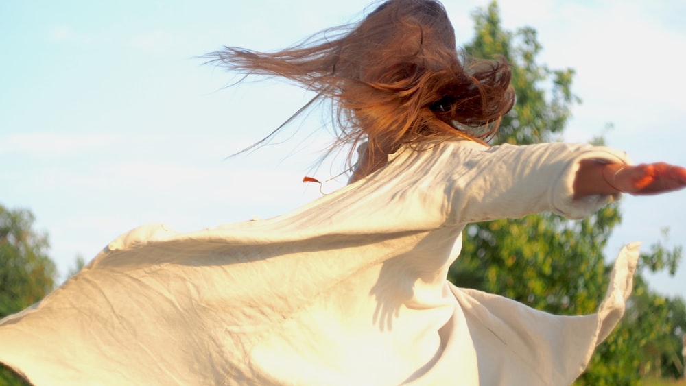 a person with the hair blowing in the wind