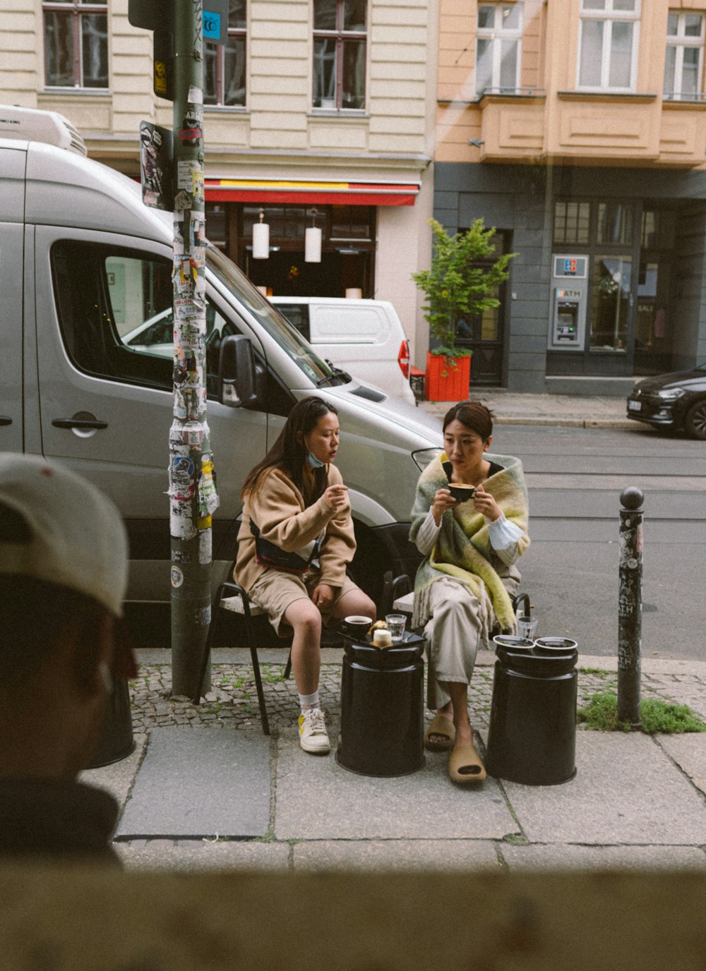 a person and a boy sitting on a bench