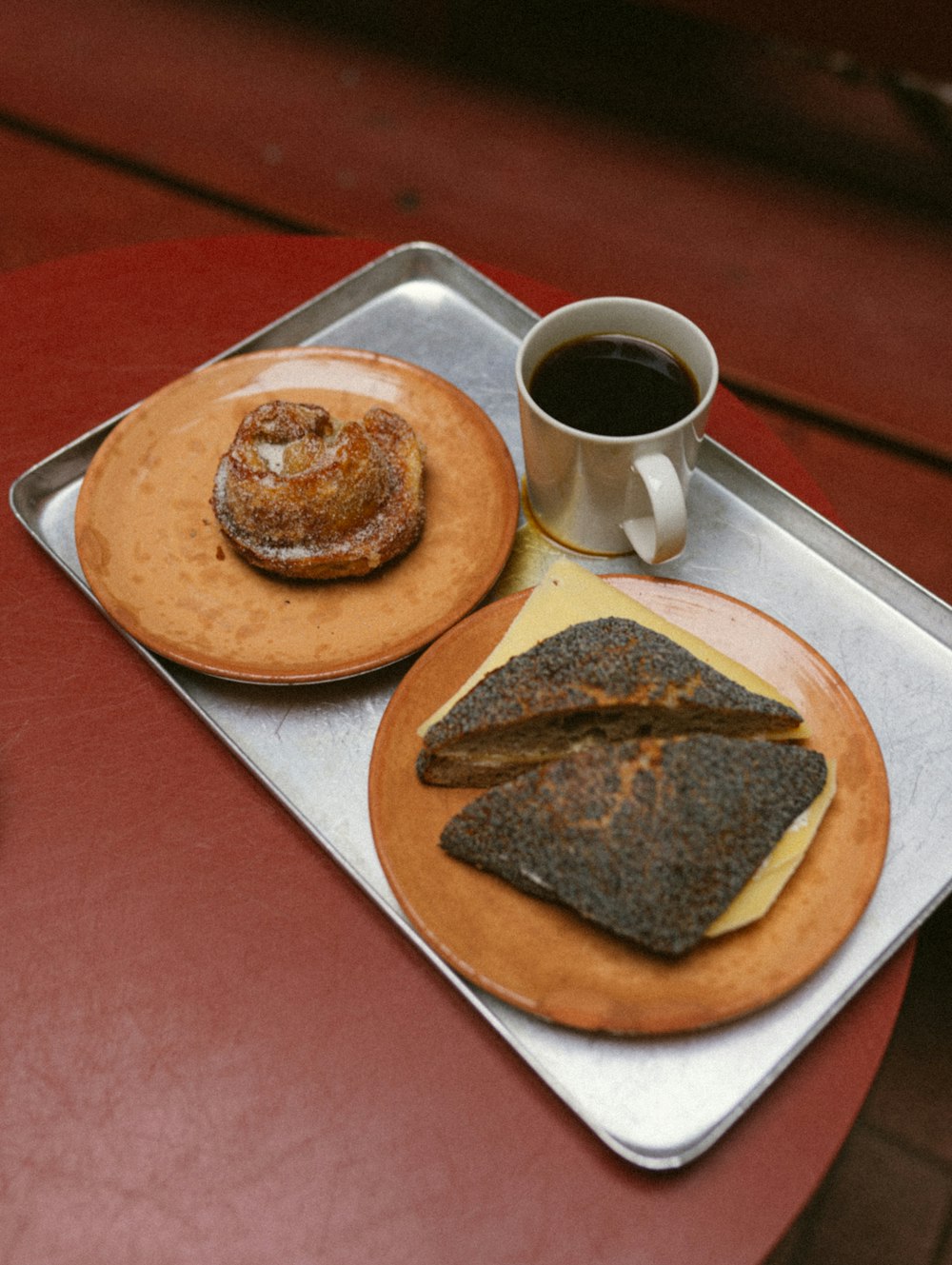 a couple of plates with food on them next to a cup of coffee