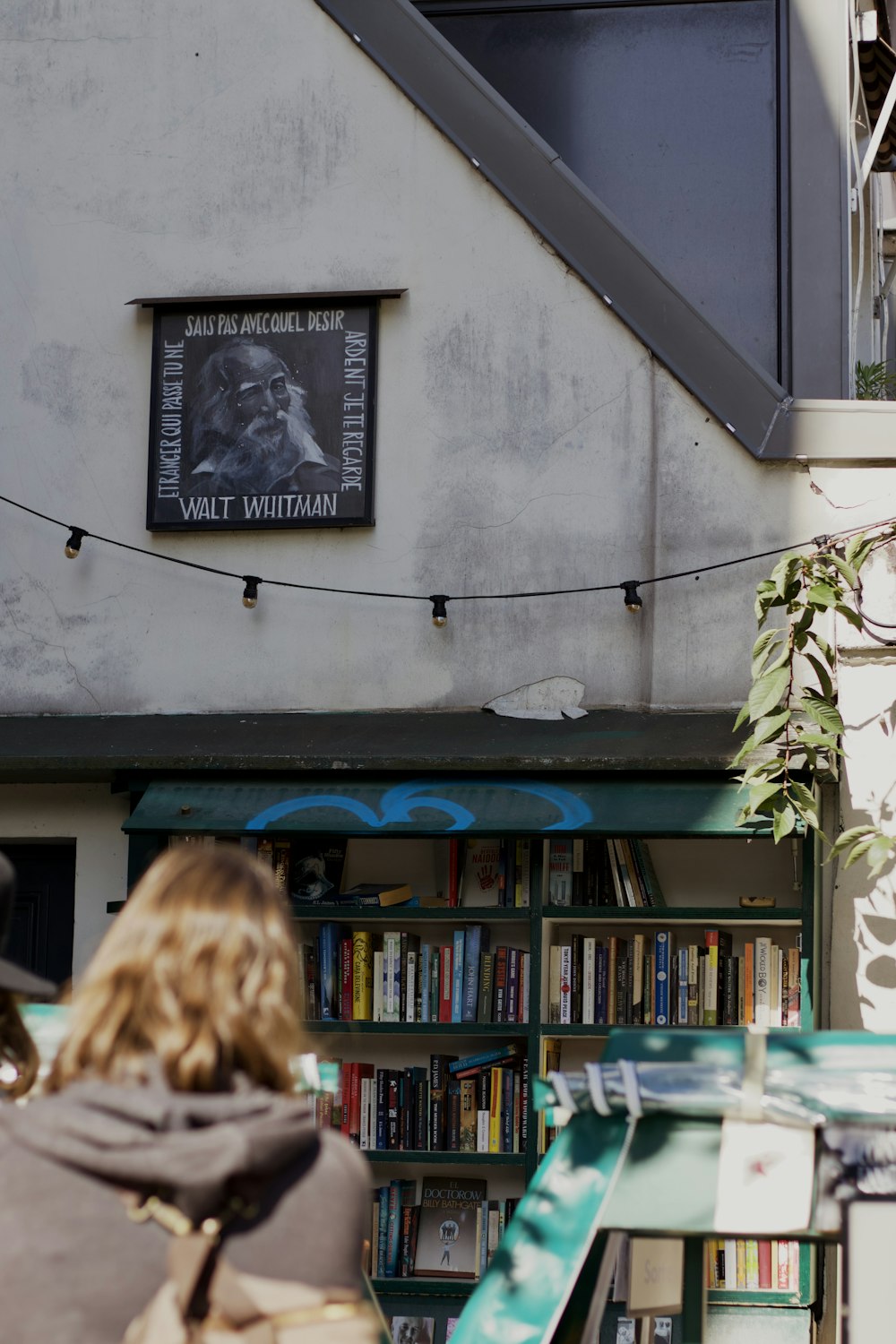 a person looking at a book shelf