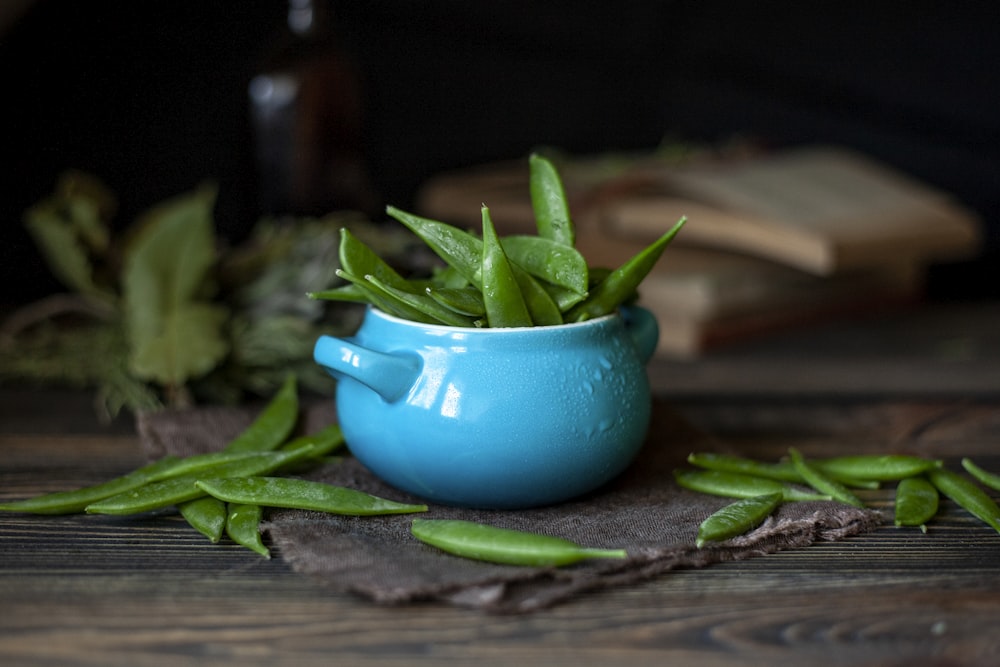 a close up of a green salad on top of a wooden table