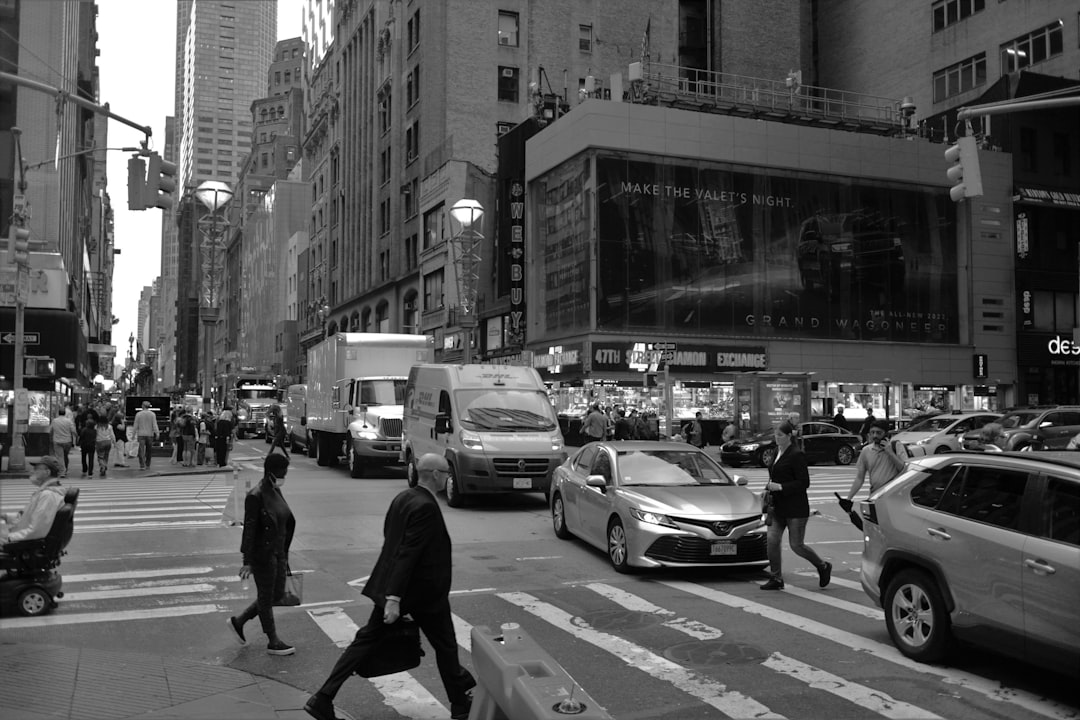 A person looking stressed while trying to balance work and study on a laptop.