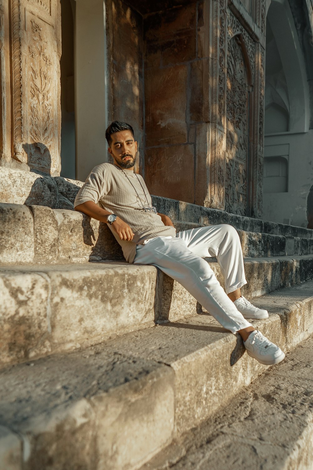 a man sitting on a stone ledge