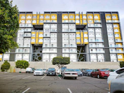 Modern apartment building exterior in Biga with bright yellow accents.