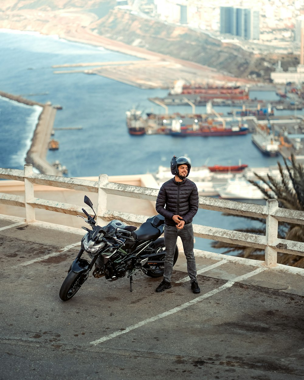 a man standing next to a motorcycle