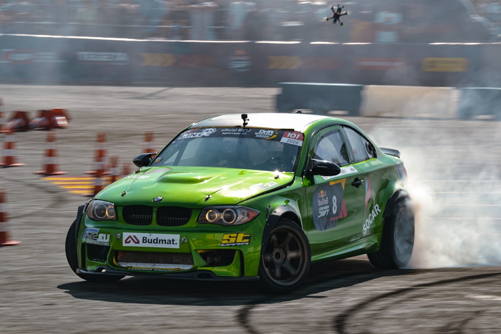 a green race car on a track