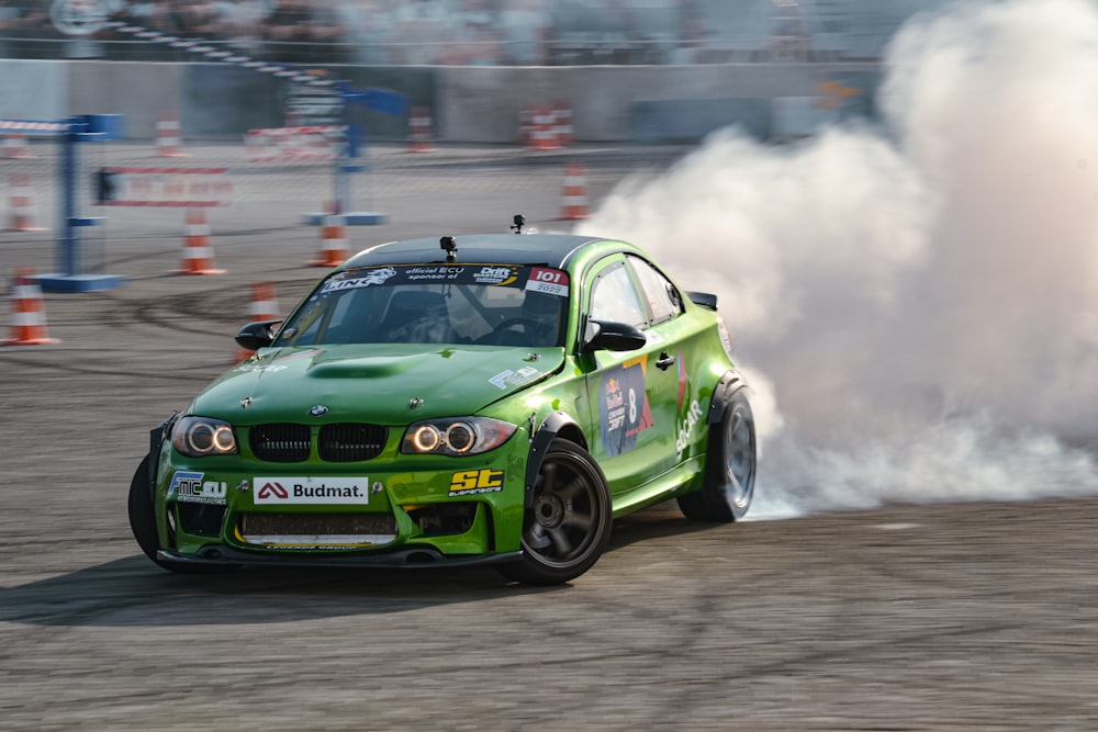 a green race car on a track