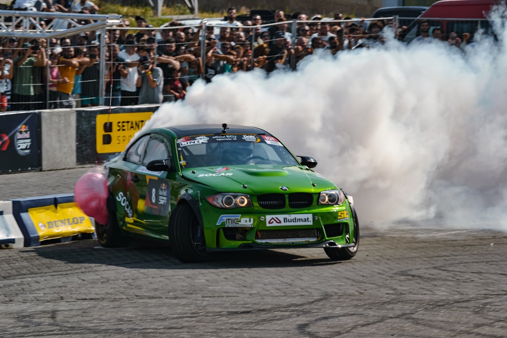 a green car with smoke coming out of it