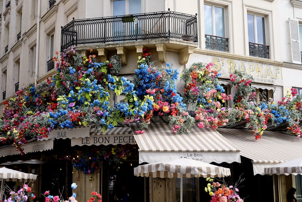 a building with many shops and flowers