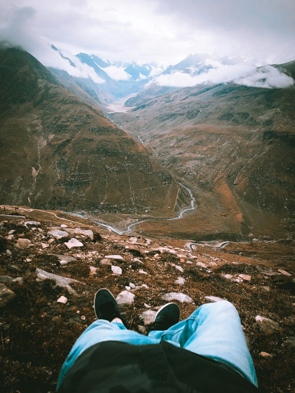 a person lying on a rocky hillside