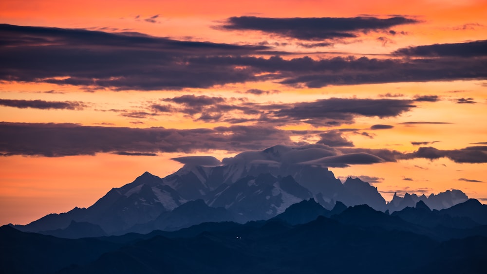 a mountain range with clouds