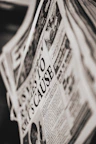 Close-up of a Tamil newspaper with bold headlines on politics and sports.